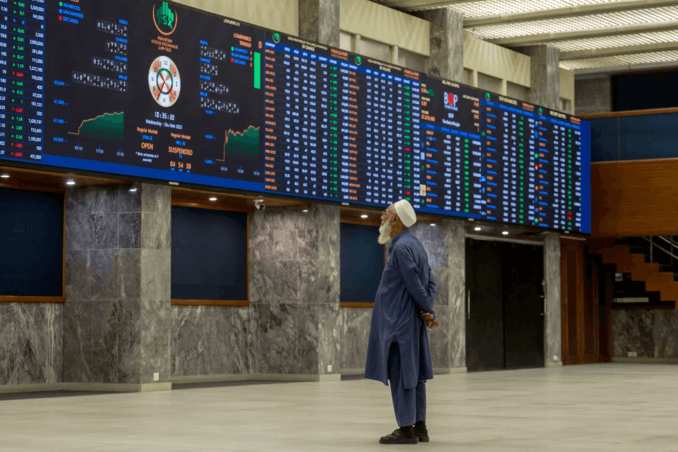 Investor looking at Pakistan Stock Exchange market quote boards